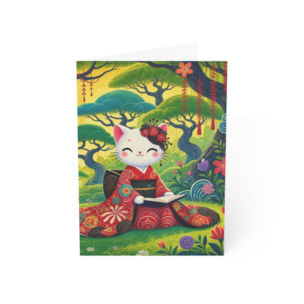 📖🌺 The Enchanted Garden Reader Kitten Greeting Card – Whimsical Japanese Garden
